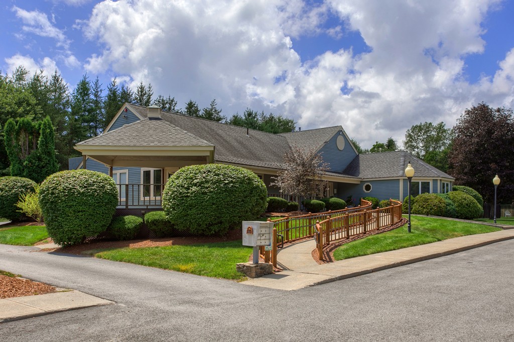 703 Ridgefield Circle, Unit A Clinton, MA 01510 - Photo 11 of 13 a front view of a house with a yard and garage