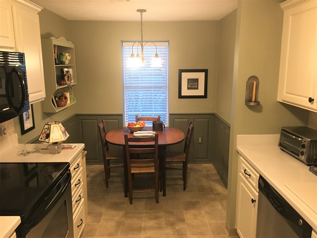 703 Ridgefield Circle, Unit A Clinton, MA 01510 - Photo 2 of 13 a dining room with a table chairs and a kitchen view