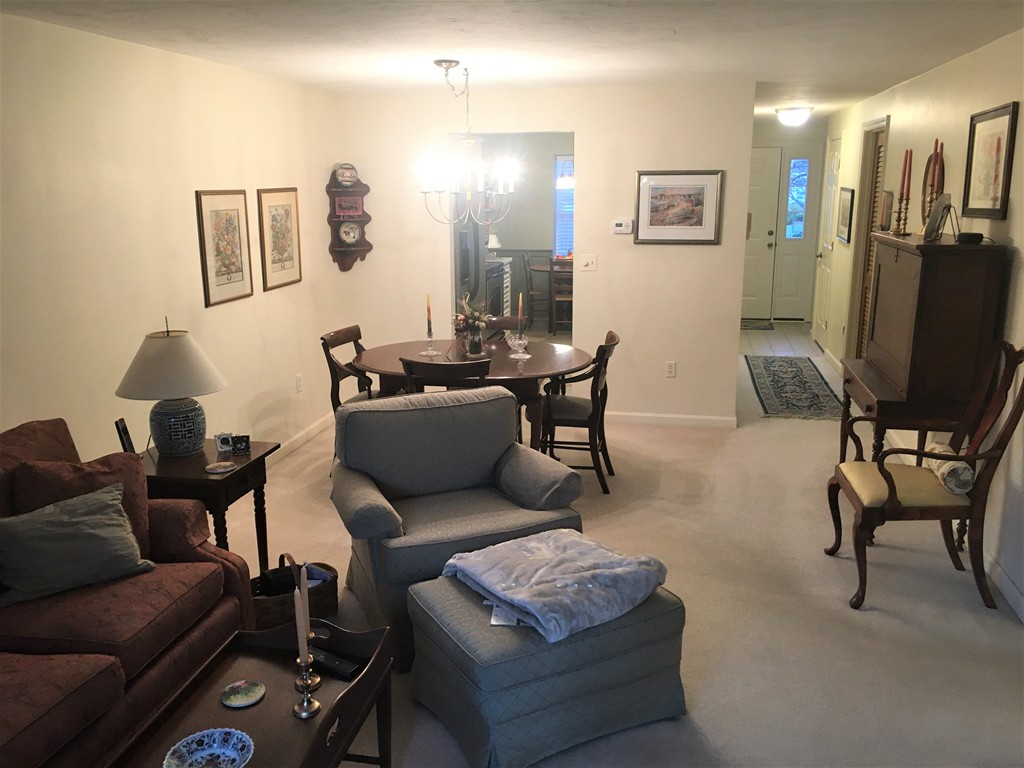 703 Ridgefield Circle, Unit A Clinton, MA 01510 - Photo 5 of 13 a living room with furniture and a flat screen tv