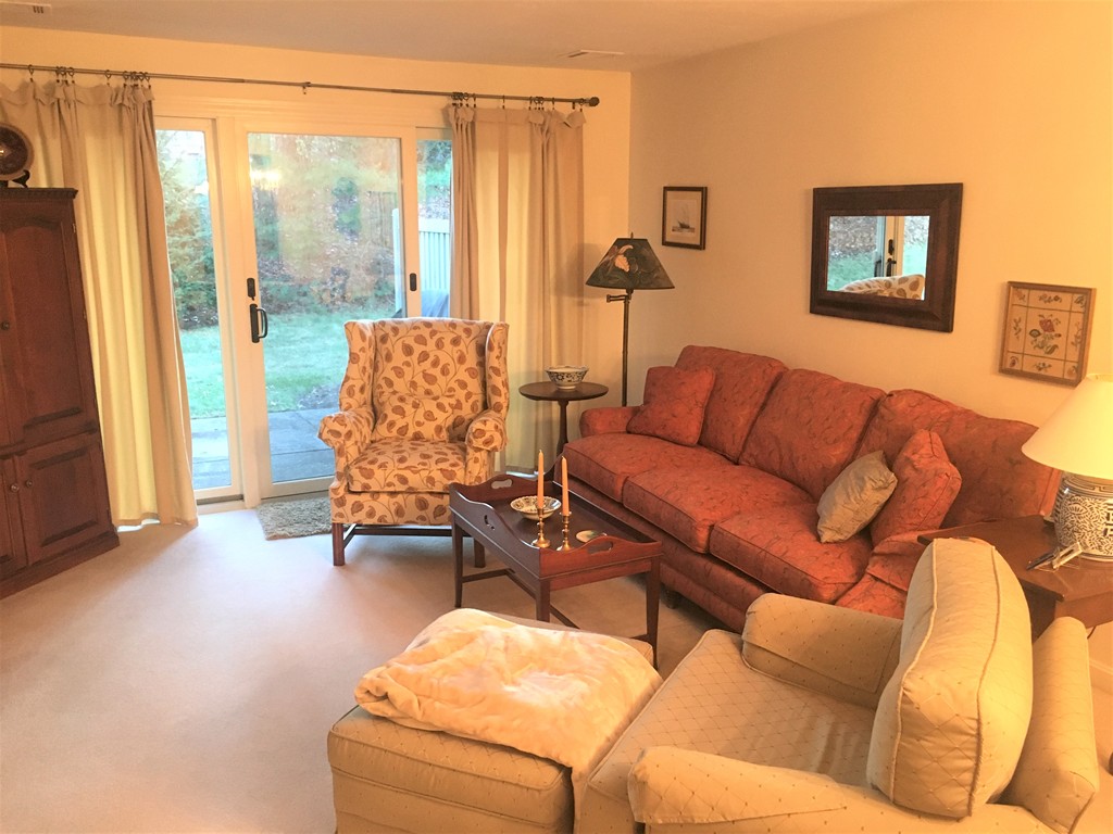 703 Ridgefield Circle, Unit A Clinton, MA 01510 - Photo 6 of 13 a living room with furniture and a flat screen tv