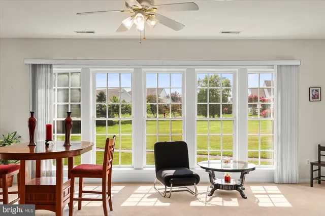 a workspace with furniture a rug and a window