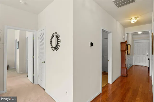 a view of hallway with wooden floor