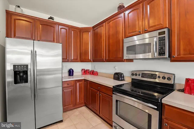 a kitchen with a refrigerator stove and microwave