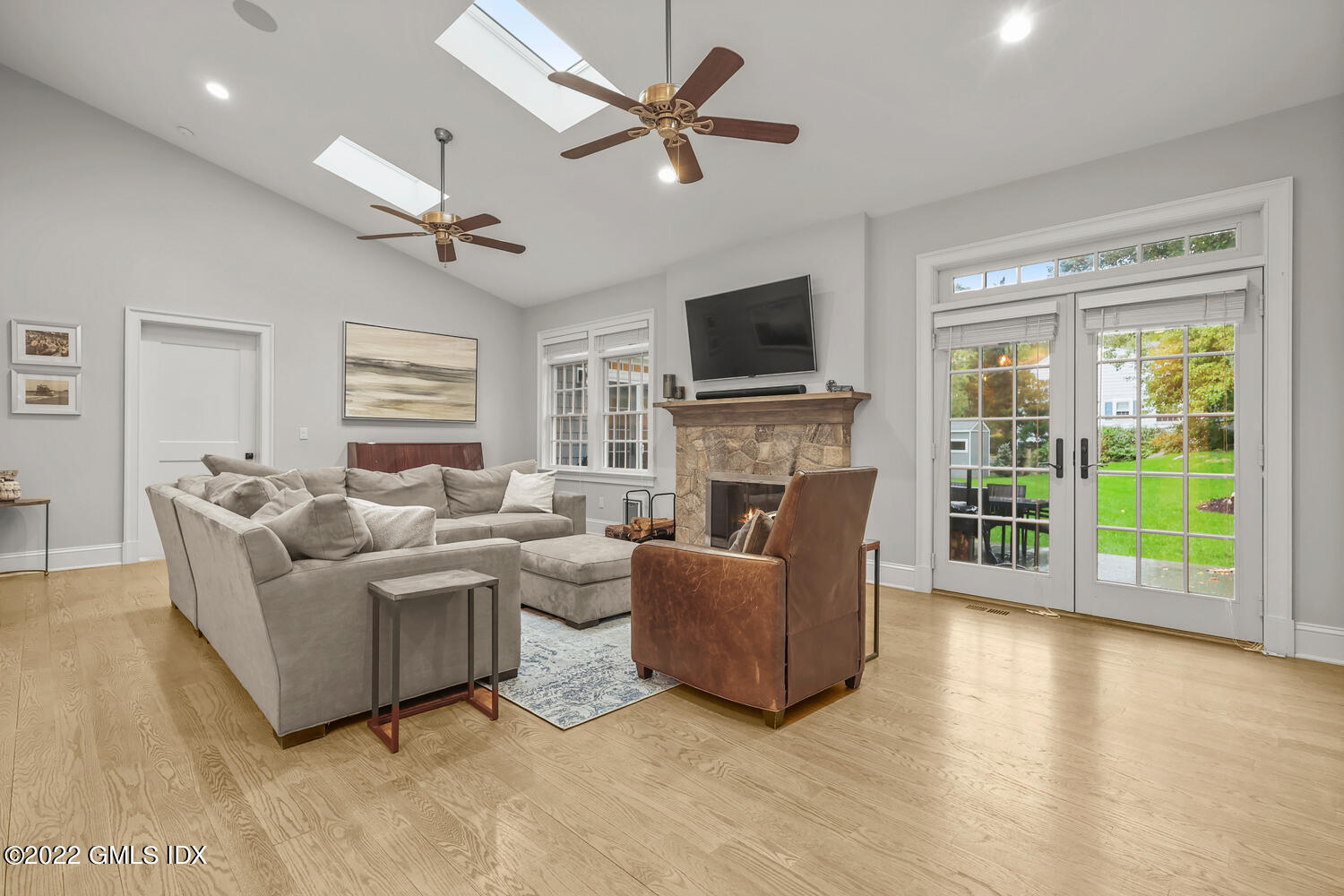 24 Neil Lane Riverside, CT 06878 - Photo 12 of 36 a living room with furniture a flat screen tv and a fireplace