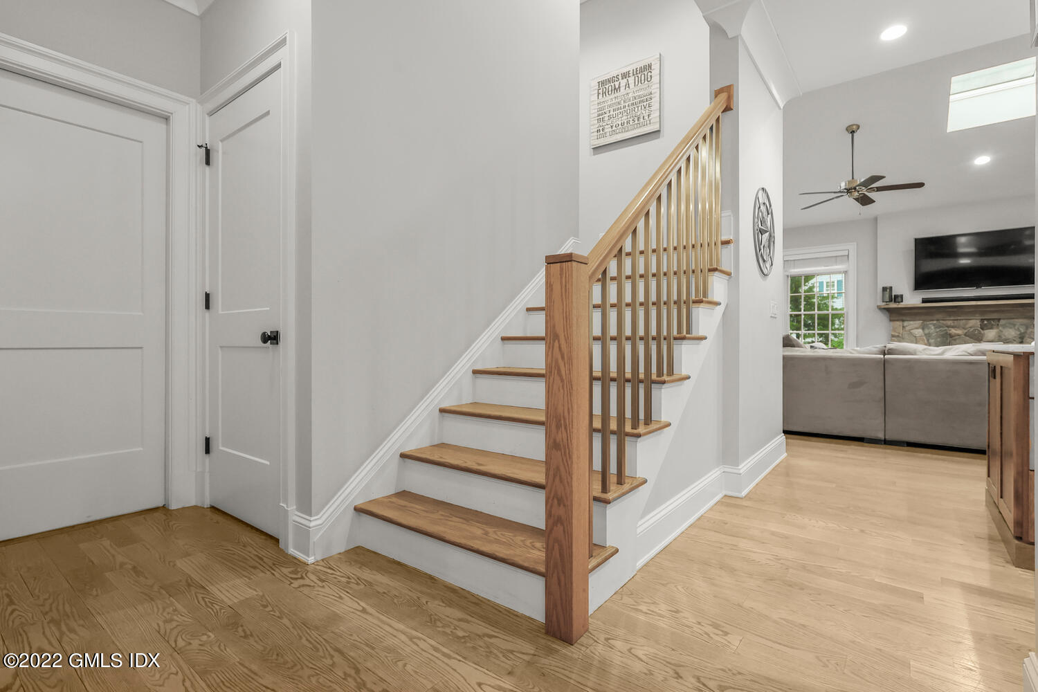 24 Neil Lane Riverside, CT 06878 - Photo 20 of 36 a view of a livingroom with wooden floor and stairs