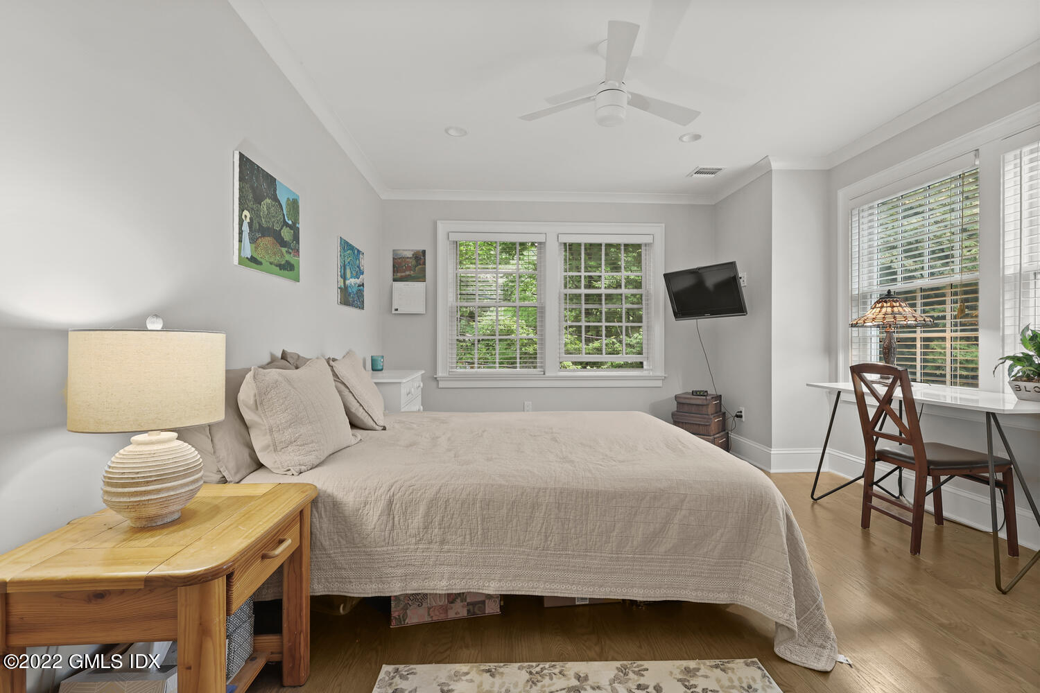 24 Neil Lane Riverside, CT 06878 - Photo 23 of 36 a bedroom with a bed and a table in it with wooden floor