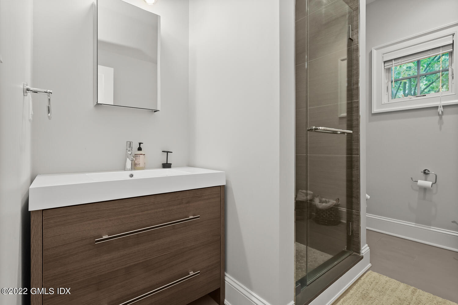 24 Neil Lane Riverside, CT 06878 - Photo 28 of 36 a bathroom with a sink mirror and shower