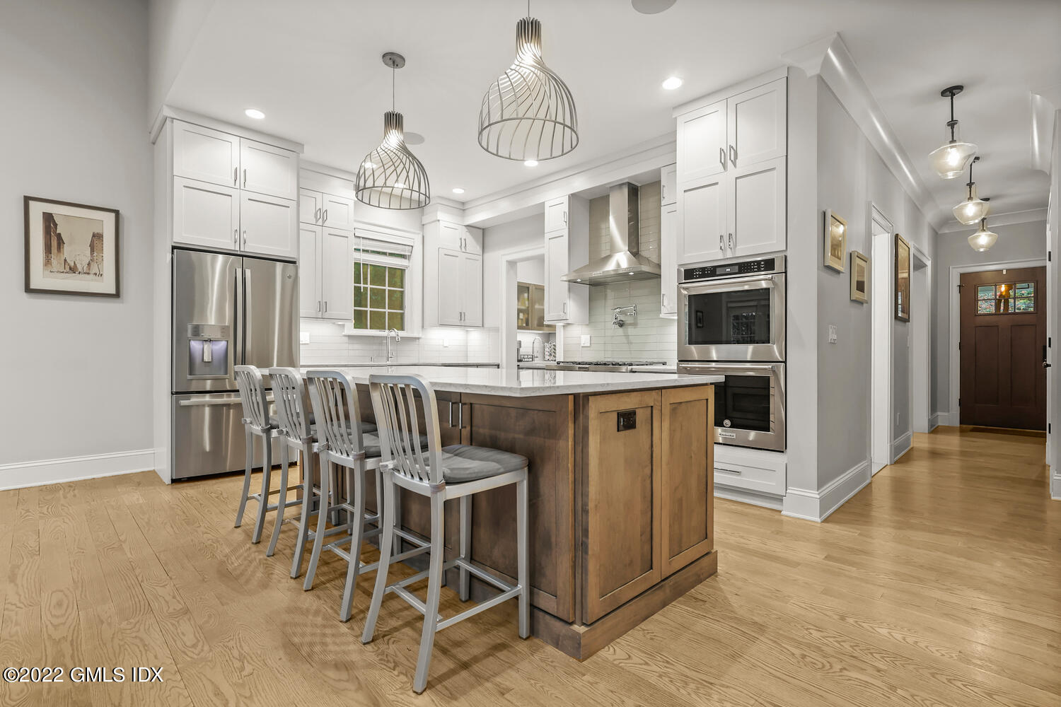 24 Neil Lane Riverside, CT 06878 - Photo 3 of 36 a kitchen with stainless steel appliances kitchen island granite countertop a table chairs and a refrigerator