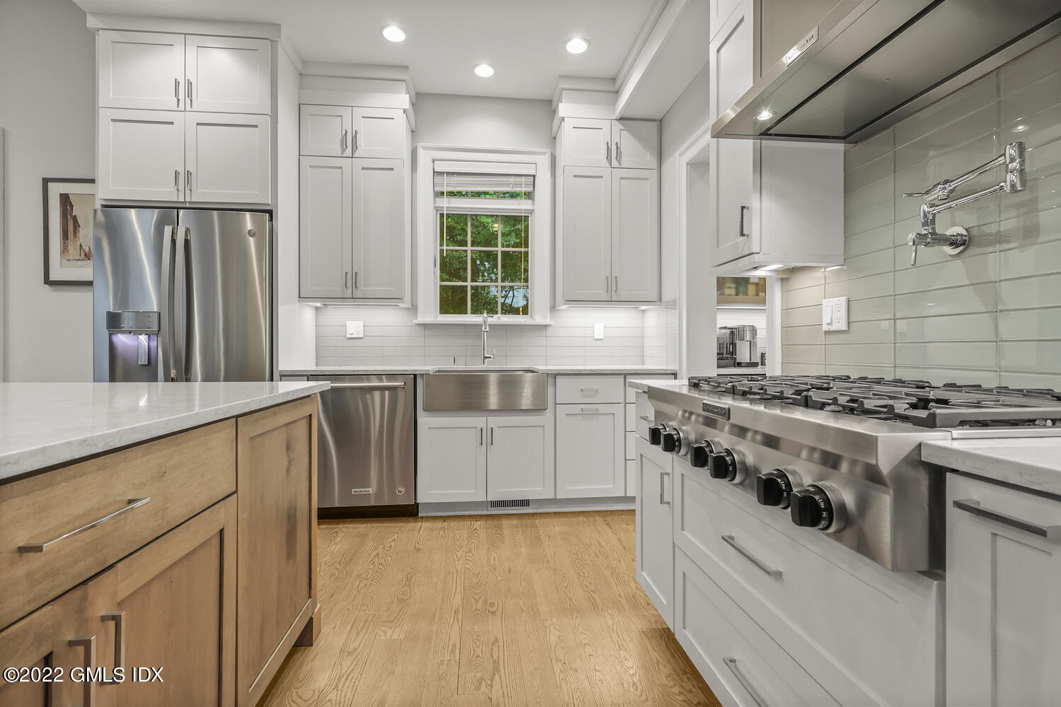 24 Neil Lane Riverside, CT 06878 - Photo 5 of 36 a kitchen with white cabinets and appliances