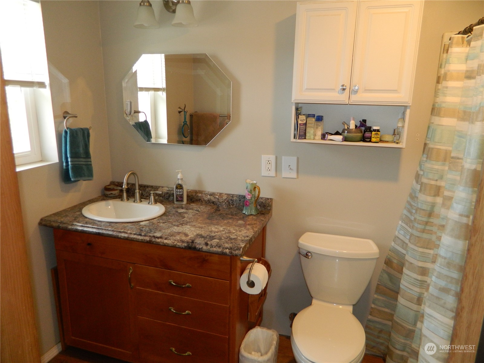 16 King Road Tonasket, WA 98855 - Photo 16 of 34 a bathroom with a granite countertop toilet sink and mirror