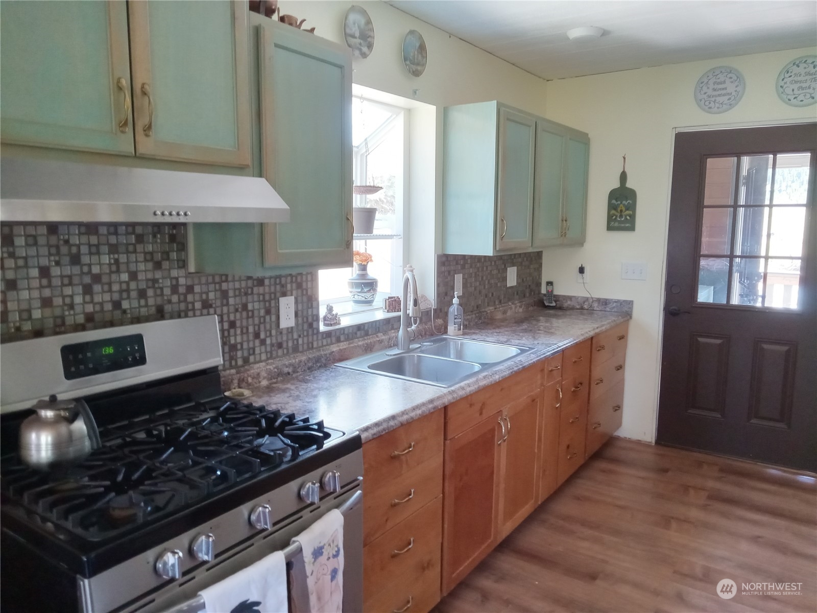 16 King Road Tonasket, WA 98855 - Photo 30 of 34 a kitchen with granite countertop a stove and a sink
