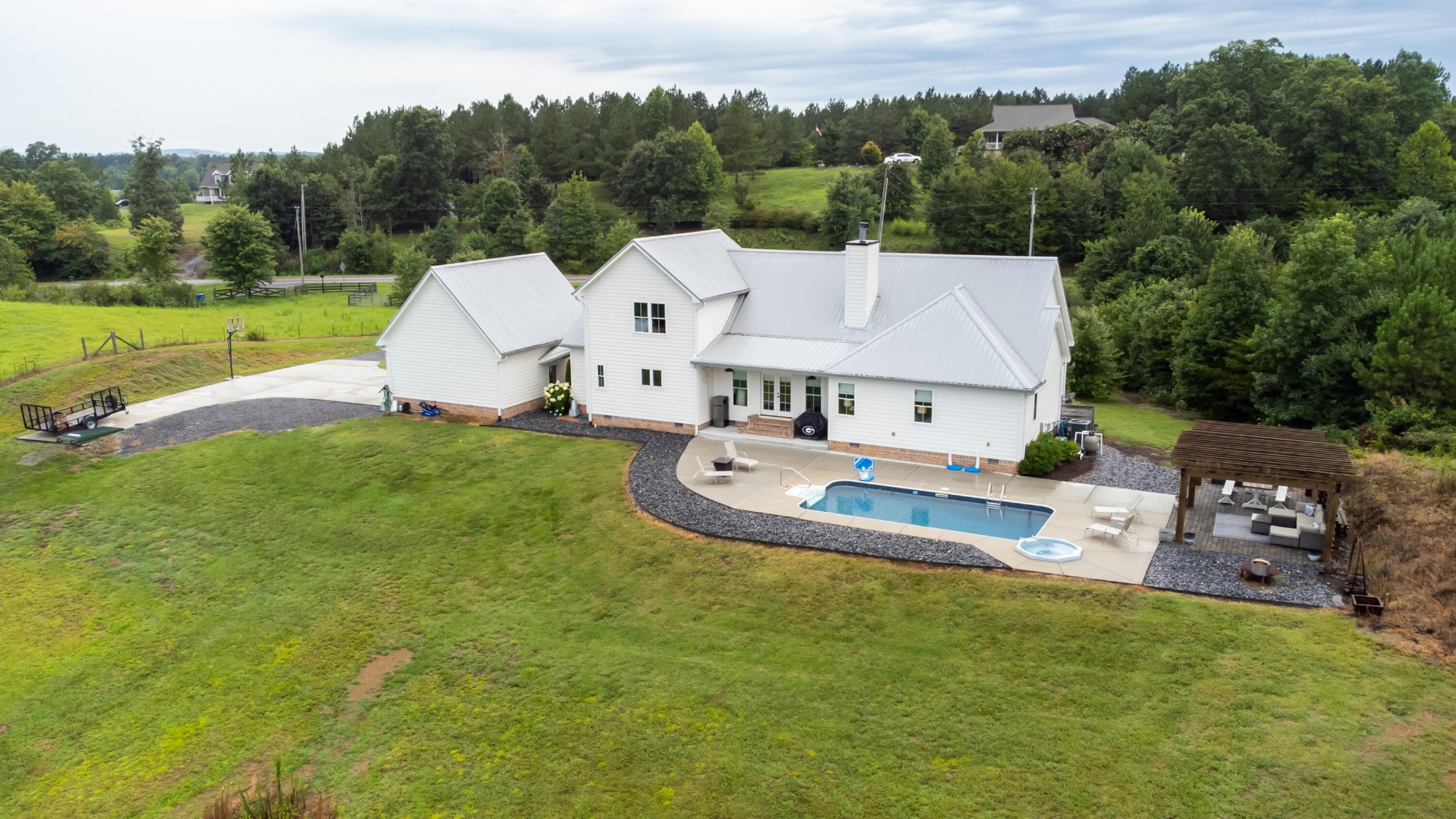6925 Spring Place Road Southeast Old Fort, TN 37362 - Photo 10 of 46 an aerial view of a house with swimming pool and trees in the background