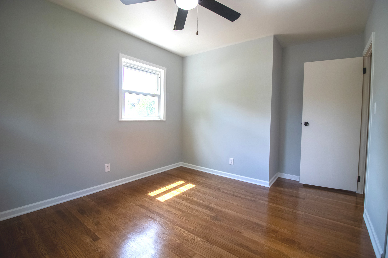 2602 Fairway Drive Joliet, IL 60435 - Photo 13 of 43 an empty room with wooden floor chandelier fan and windows