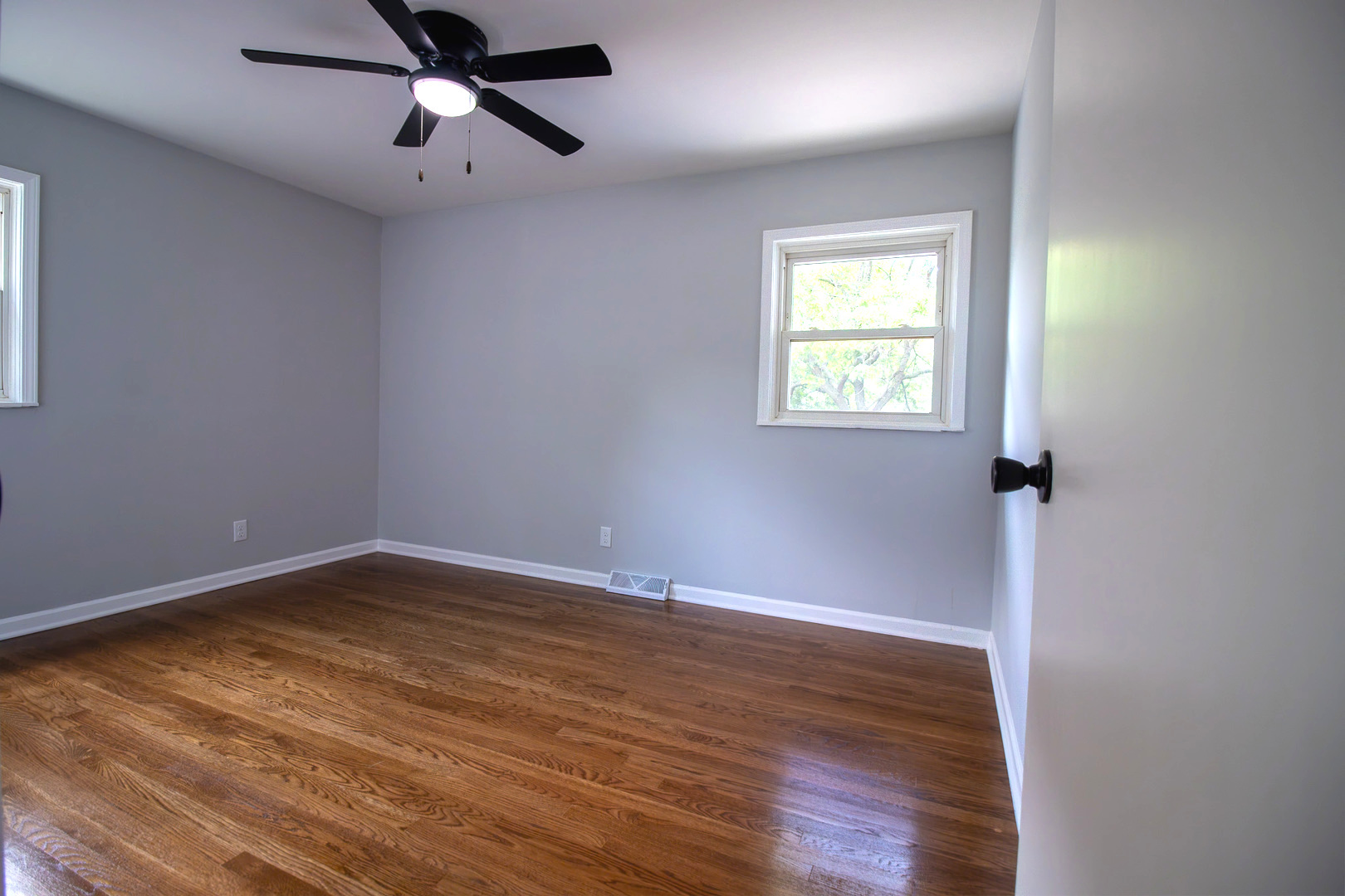 2602 Fairway Drive Joliet, IL 60435 - Photo 16 of 43 an empty room with wooden floor fan and windows