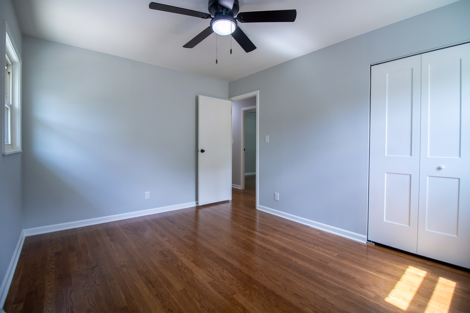 2602 Fairway Drive Joliet, IL 60435 - Photo 19 of 43 an empty room with wooden floor and windows