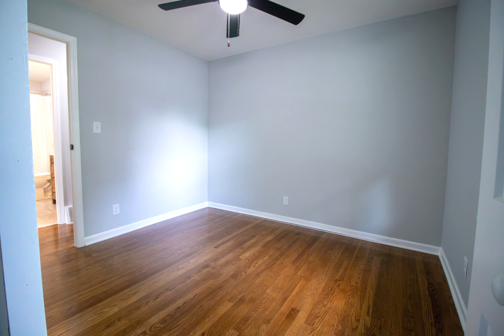 2602 Fairway Drive Joliet, IL 60435 - Photo 21 of 43 an empty room with wooden floor chandelier fan and windows