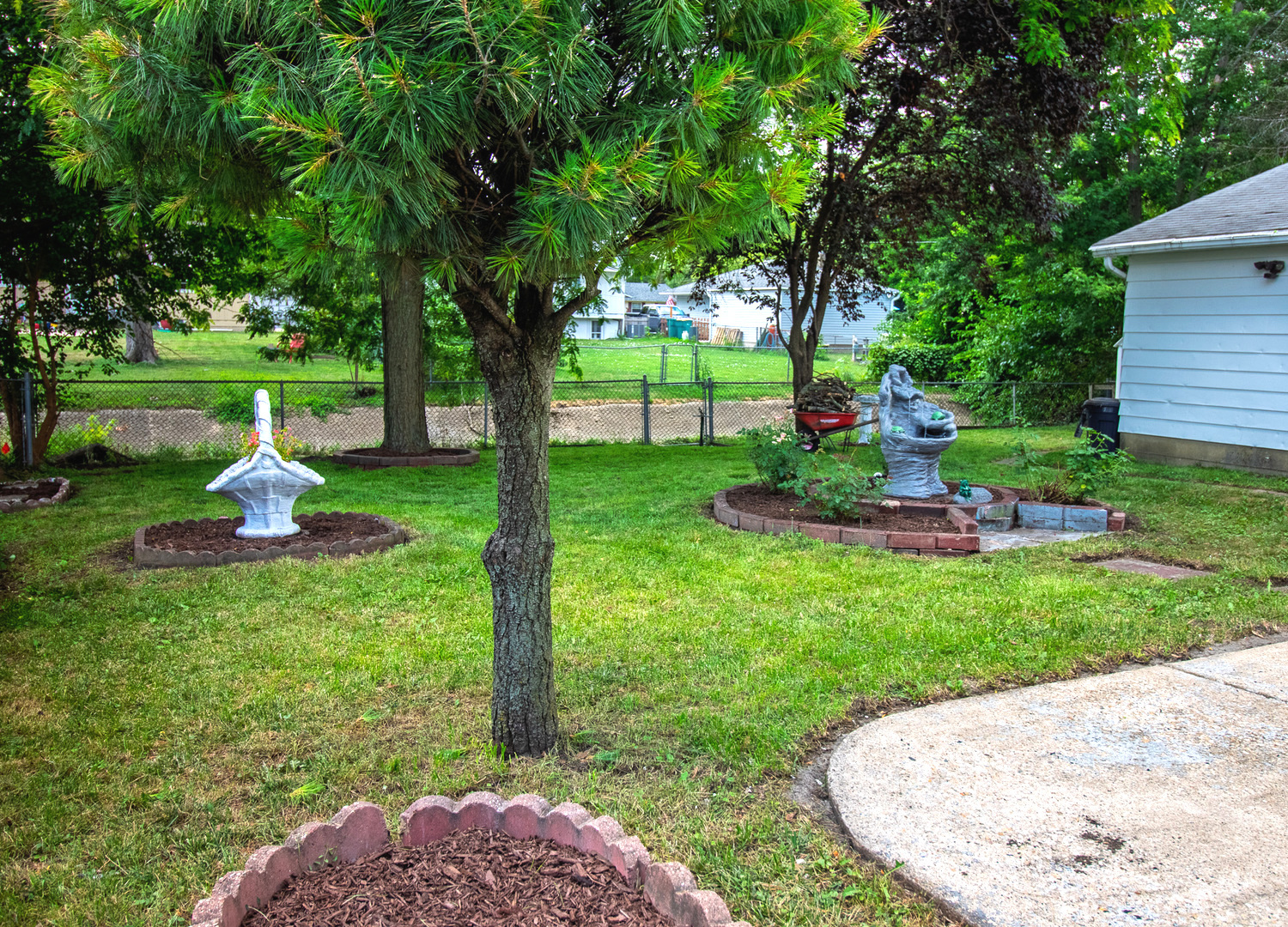 2602 Fairway Drive Joliet, IL 60435 - Photo 38 of 43 a view of a garden with a slide and a bench