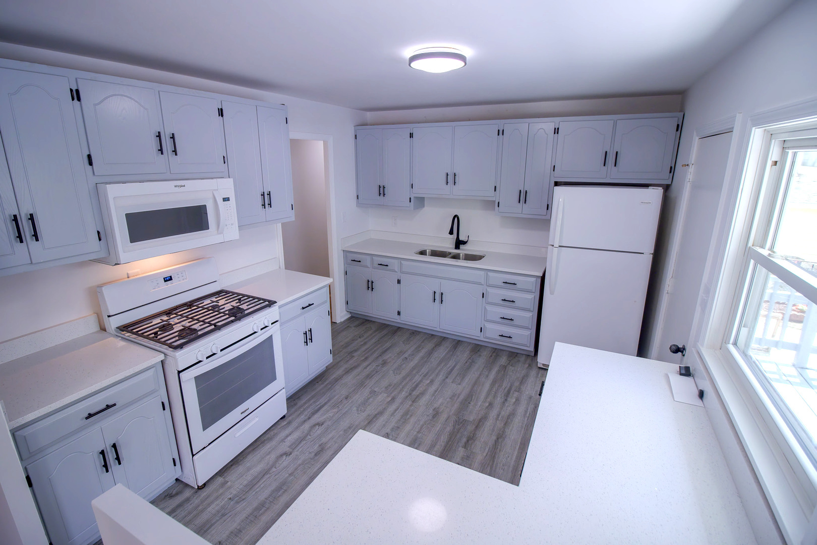 2602 Fairway Drive Joliet, IL 60435 - Photo 10 of 43 a kitchen with white cabinets sink and stainless steel appliances