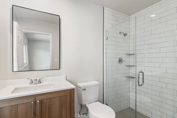 a kitchen that has a sink cabinets stainless steel appliances and wooden floor