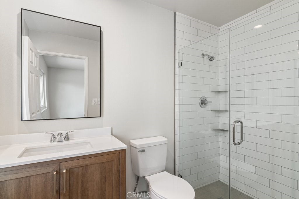 28548 Middlebury Way Menifee, CA 92586 - Photo 12 of 15 a bathroom with a toilet sink vanity granite and shower