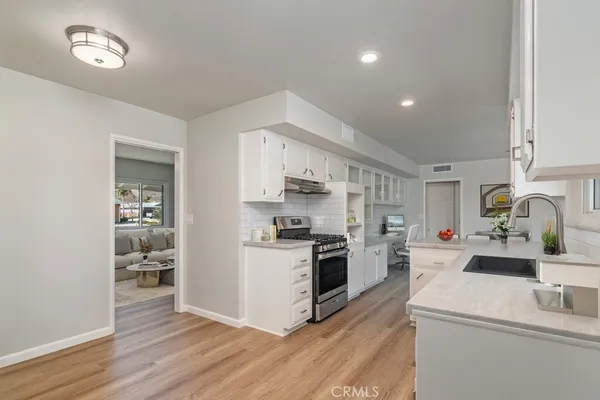 a kitchen with a cabinets and wooden floor