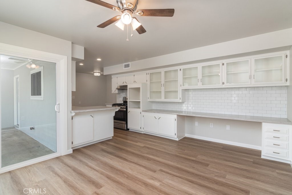 28548 Middlebury Way Menifee, CA 92586 - Photo 14 of 15 a kitchen with a cabinets and wooden floor