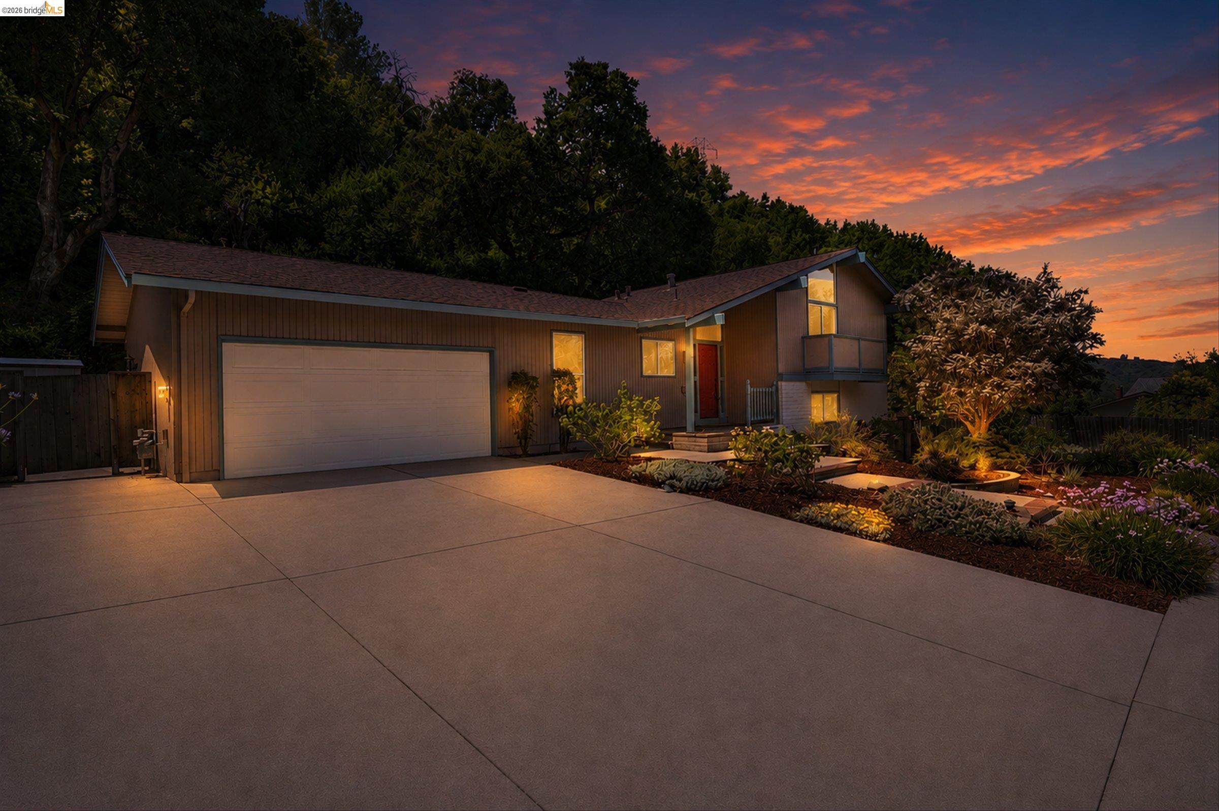 2826 Wright Avenue Pinole, CA 94564 - Photo 4 of 70 Modern split-level residence featuring a two-car garage, mature landscaping, and multi-level exterior lighting