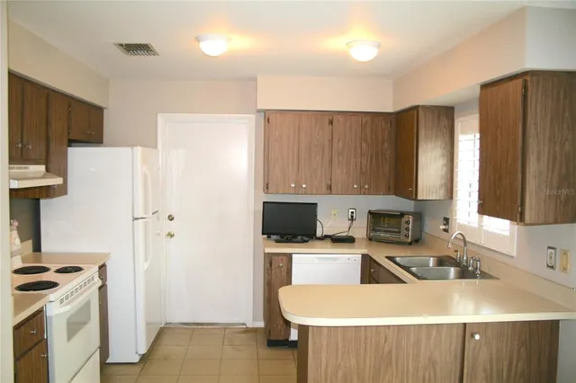 a kitchen with a sink a stove and refrigerator