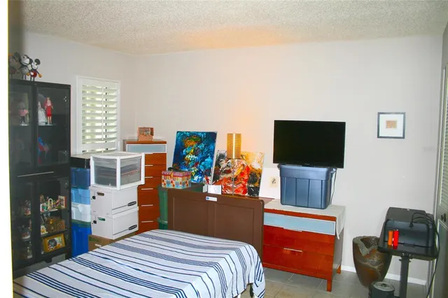 a bedroom with a bed and flat screen tv