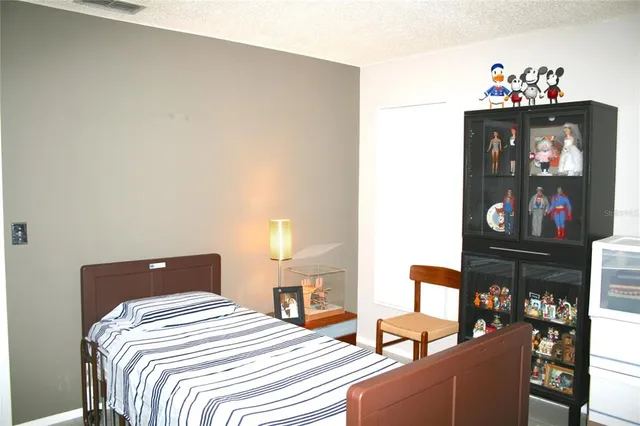 a bedroom with a bed and dresser