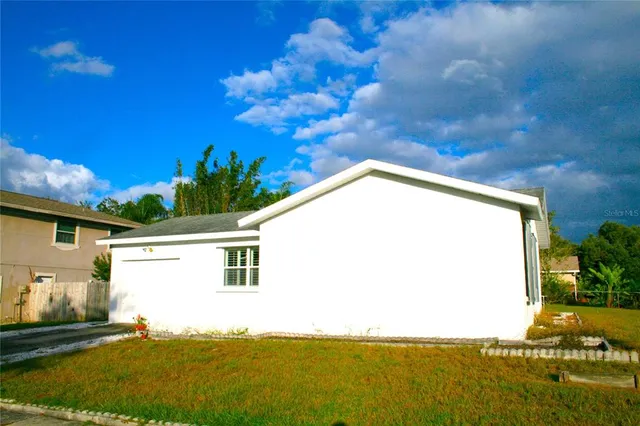 a view of a backyard with plants and a patio