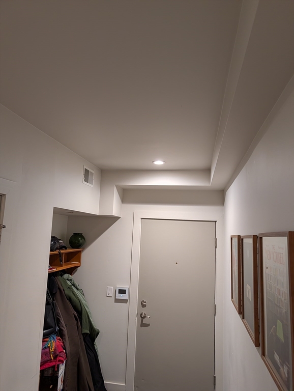 3383 Washington Street, Unit 201 Boston, MA 02130 - Photo 14 of 15 a view of walk in closet with clothes and shoes