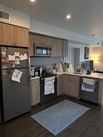 a kitchen with a sink a stove and cabinets