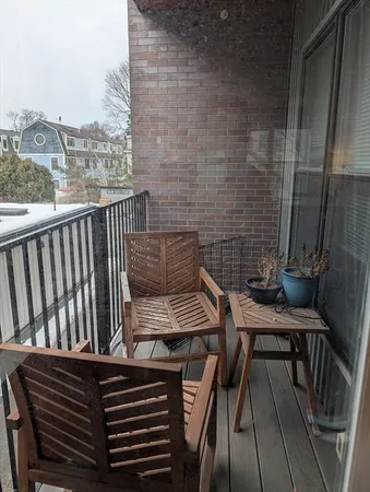 a view of a balcony with two chairs and a table