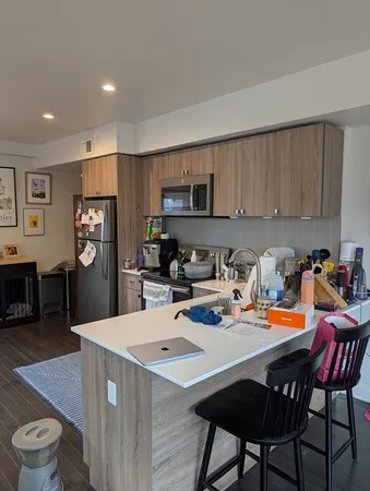 a kitchen with a dining table chairs and a refrigerator