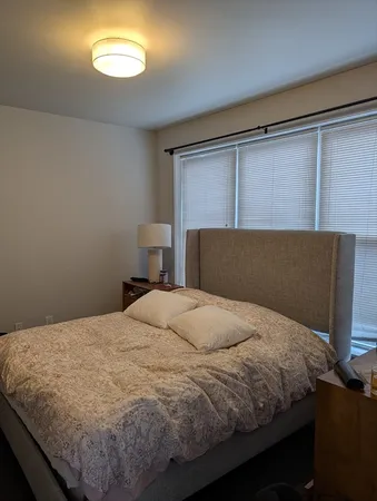 a bedroom with a bed and window