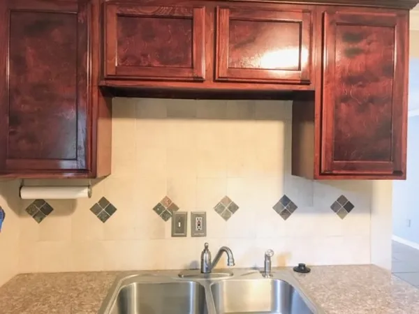 a kitchen with a sink and a window