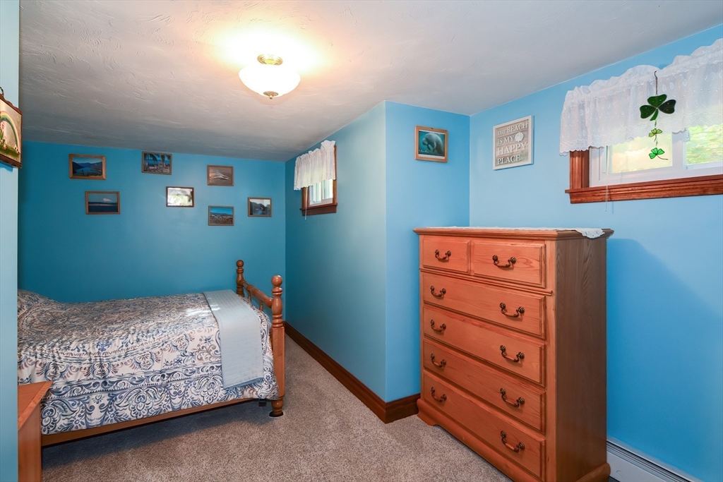 115 Wickaboag Valley Road West Brookfield, MA 01585 - Photo 14 of 31 a bedroom with a bed and a lamp on dresser