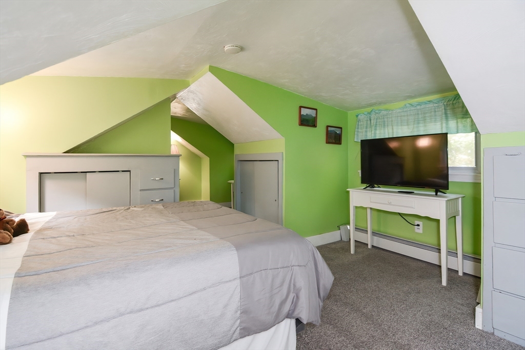 115 Wickaboag Valley Road West Brookfield, MA 01585 - Photo 20 of 31 a bedroom with a bed and a flat screen tv