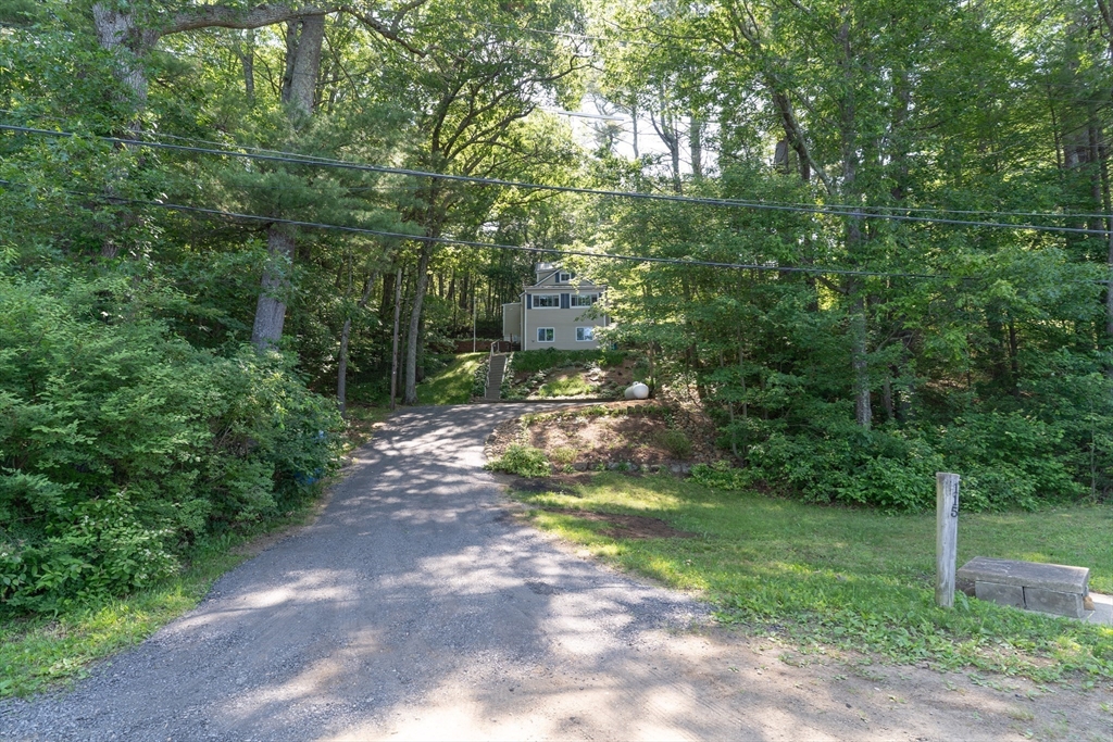 115 Wickaboag Valley Road West Brookfield, MA 01585 - Photo 2 of 31 a view of a yard with trees in the background