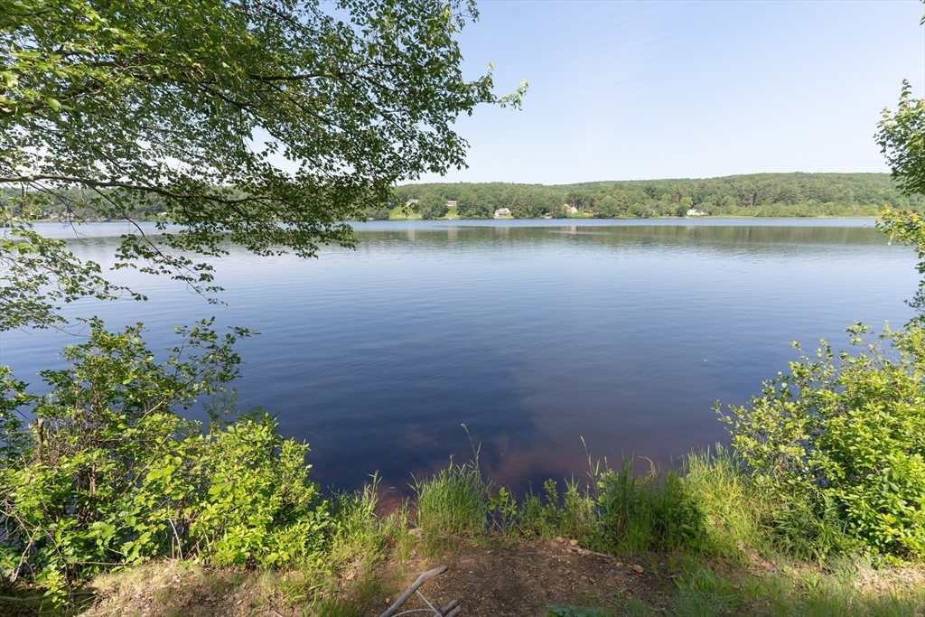 115 Wickaboag Valley Road West Brookfield, MA 01585 - Photo 30 of 31 a view of a lake with a house in the background