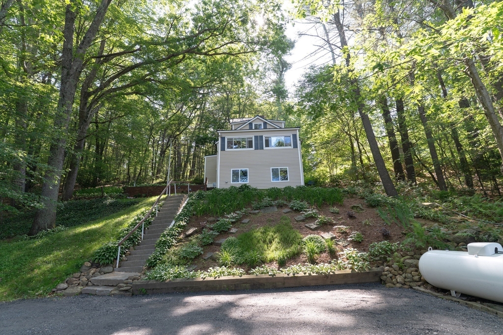 115 Wickaboag Valley Road West Brookfield, MA 01585 - Photo 31 of 31 a view of a house with a yard and large trees