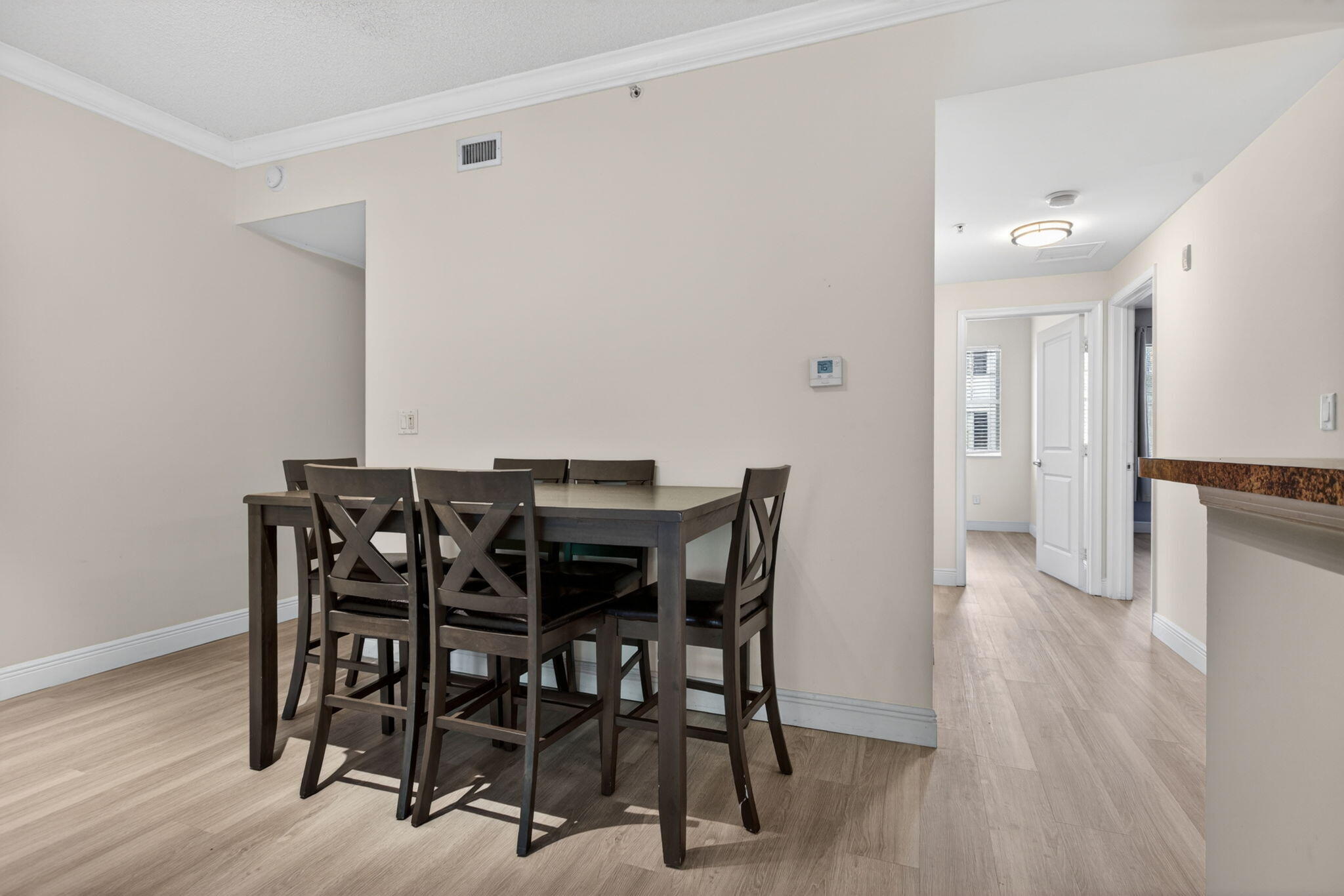5880 West Sample Road, Unit 206 Coral Springs, FL 33067 - Photo 7 of 37 a view of a dining room with furniture and wooden floor