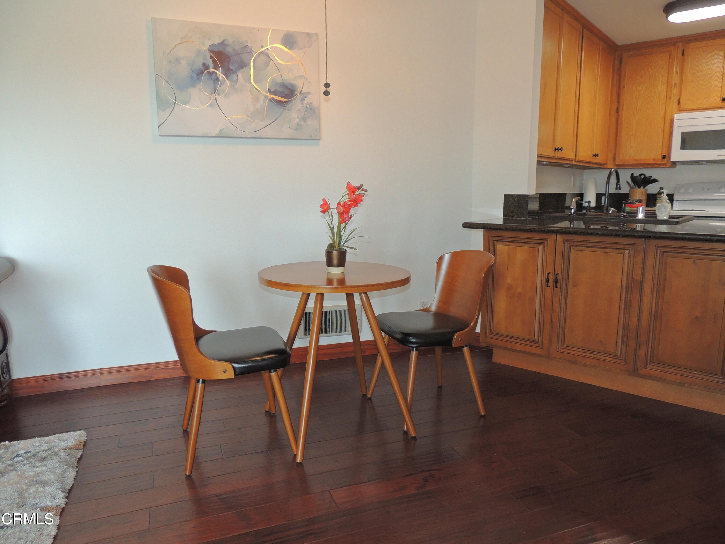 2901 Peninsula Road, Unit 237 Oxnard, CA 93035 - Photo 12 of 35 a dining room with furniture and wooden floor