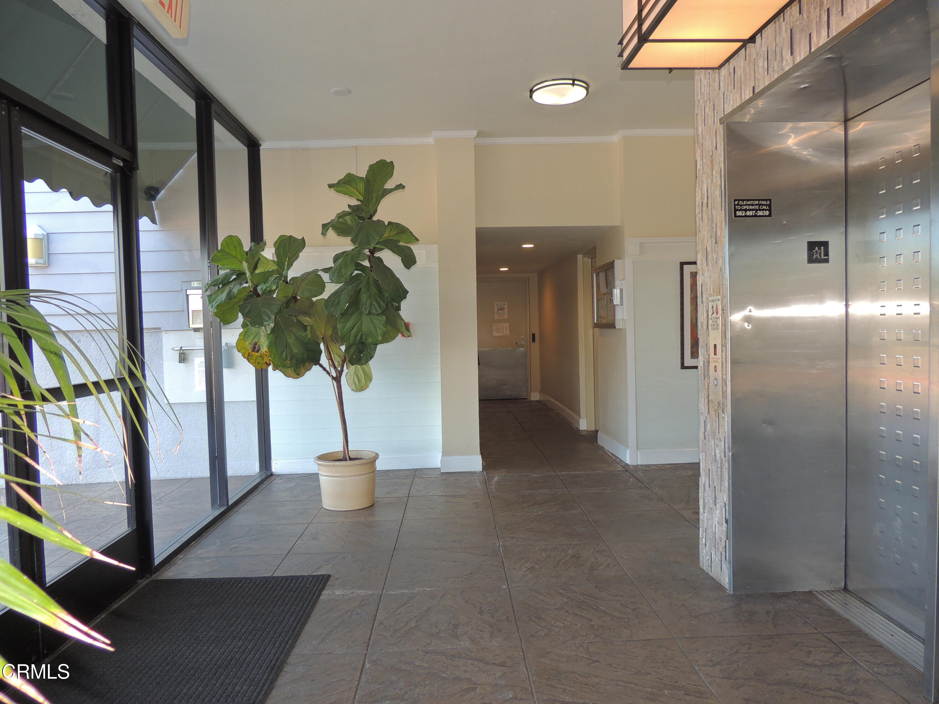 2901 Peninsula Road, Unit 237 Oxnard, CA 93035 - Photo 3 of 35 a view of a hallway with wooden floor and a potted plant
