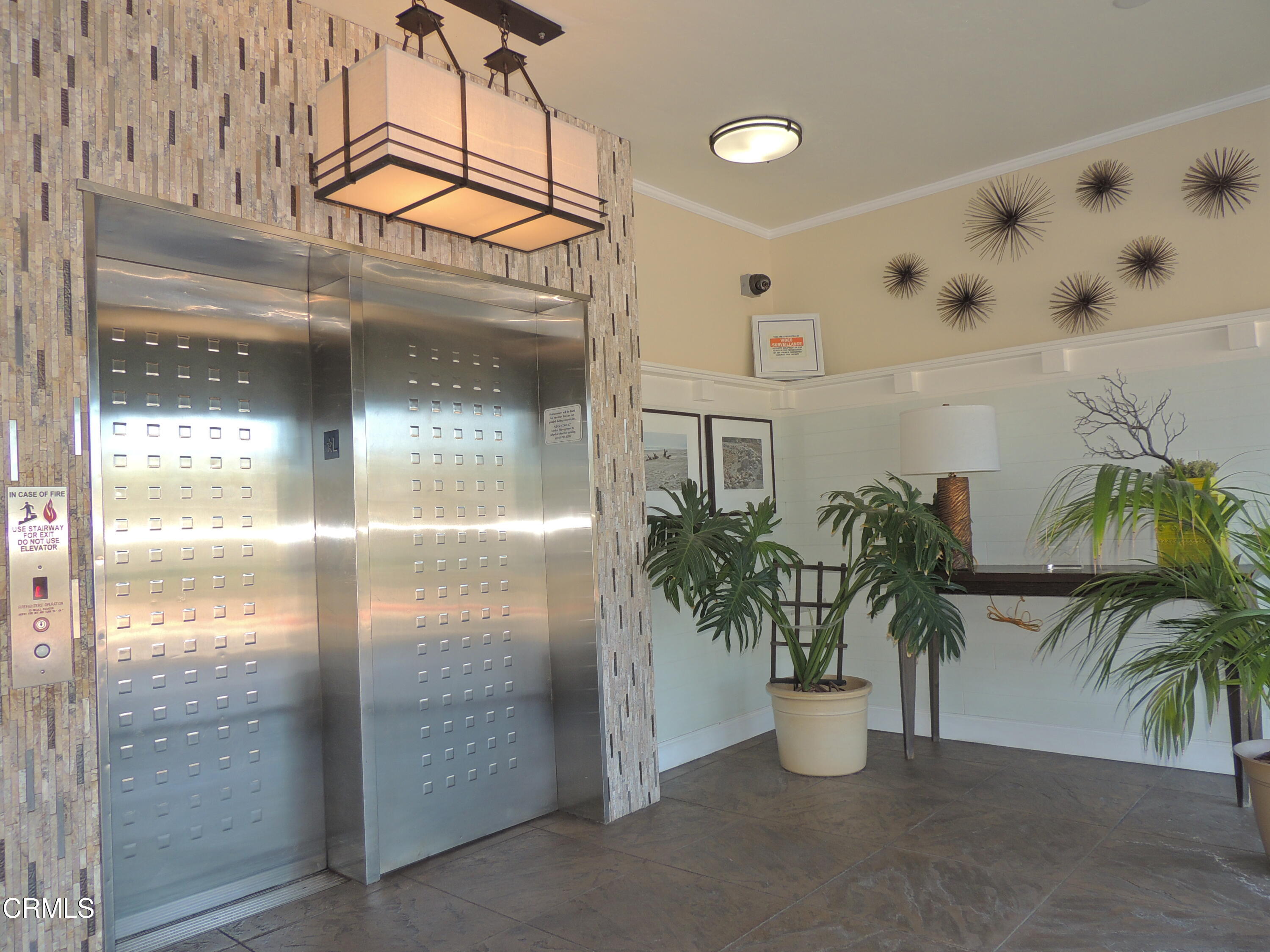 2901 Peninsula Road, Unit 237 Oxnard, CA 93035 - Photo 4 of 35 a potted plant in front of a glass door