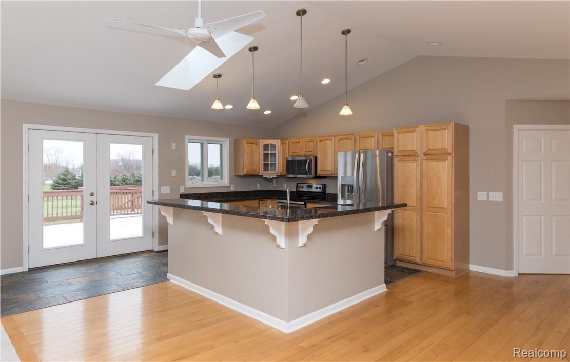 10898 Braun Road Manchester, MI 48158 - Photo 12 of 32 Island offers ample area for extra seating and Access to Deck is located off Kitchen