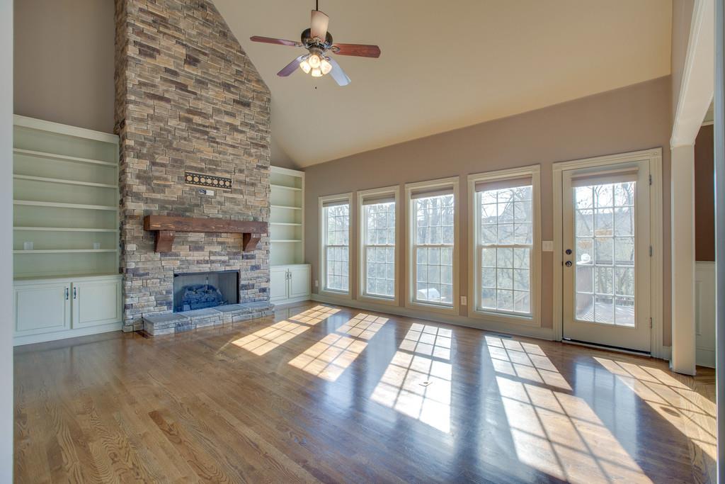 1007 Spruce Ridge Lane Spring Hill, TN 37174 - Photo 6 of 21 A wall of windows bring in lots of light in the great room which features a beautiful stone fireplace.
