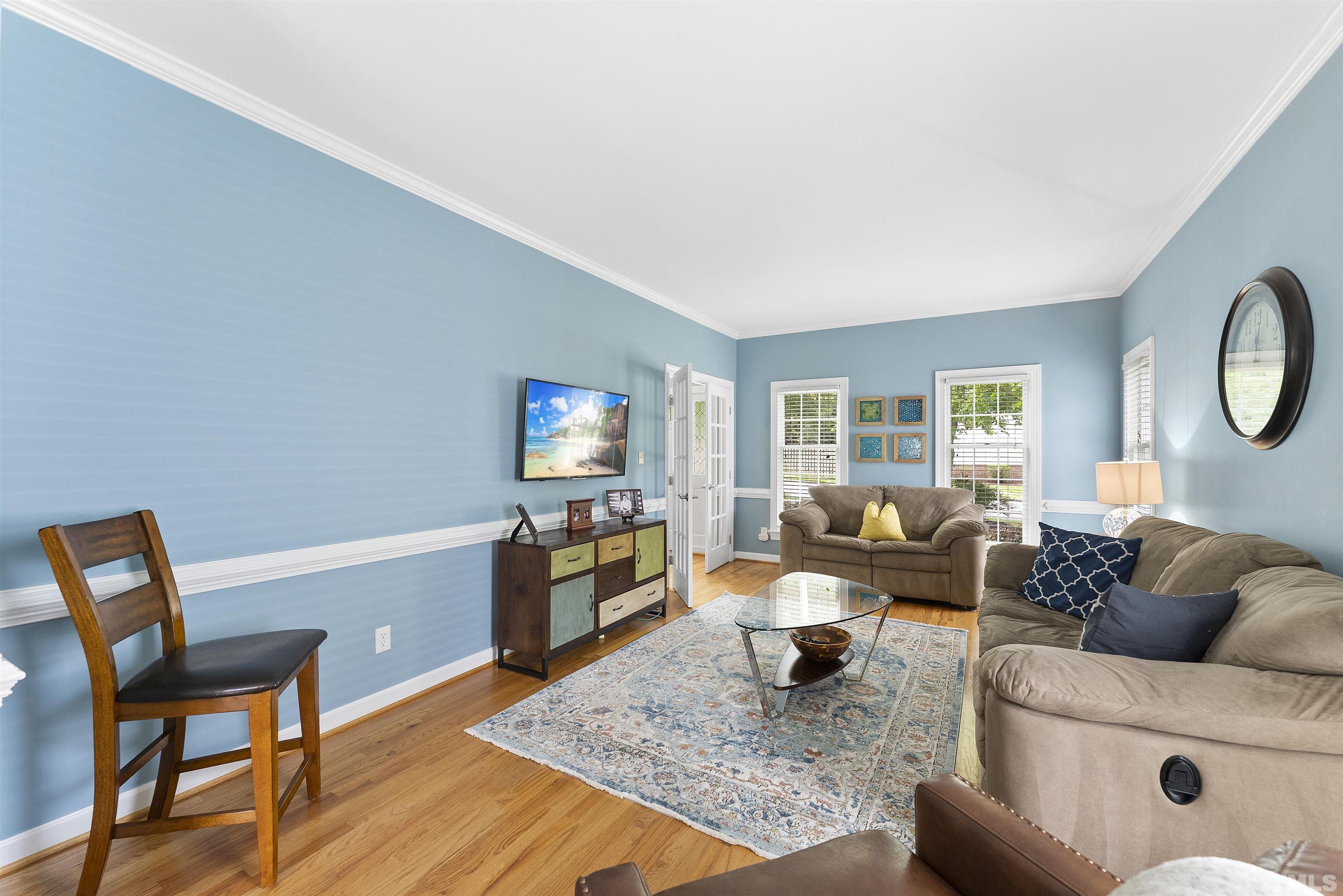 12304 Tappersfield Court Raleigh, NC 27613 - Photo 17 of 41 a living room with furniture and a flat screen tv