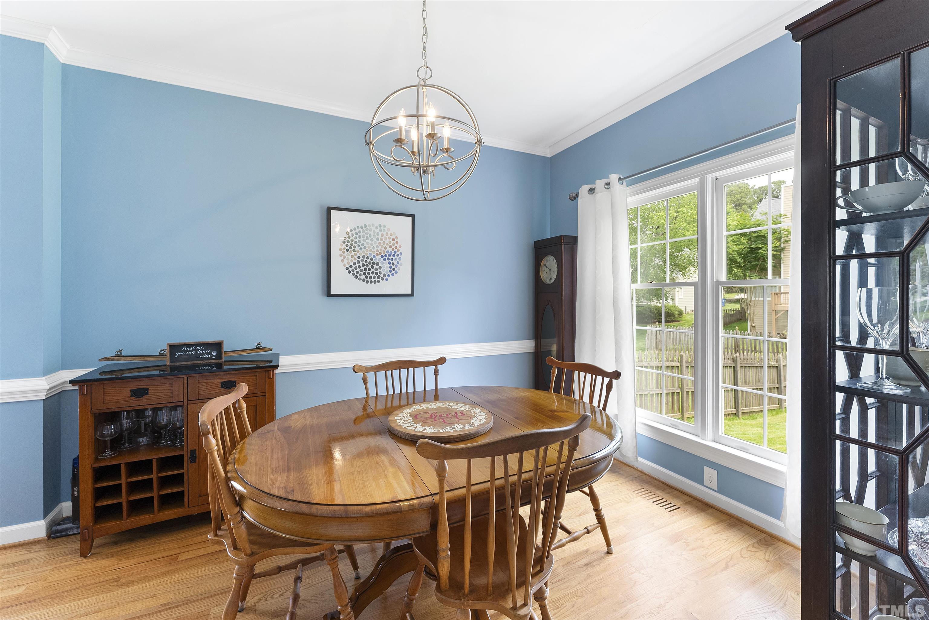 12304 Tappersfield Court Raleigh, NC 27613 - Photo 18 of 41 a view of a dining room with furniture wooden floor and chandelier